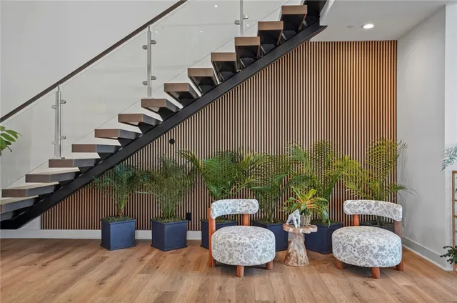 a view of entryway and hall with wooden floor