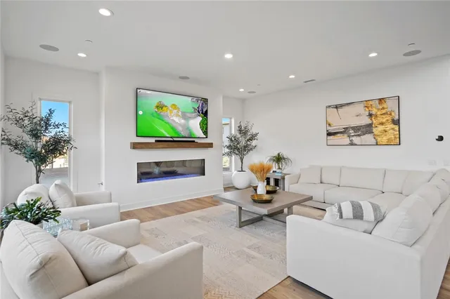 a living room with furniture a fireplace and a flat screen tv