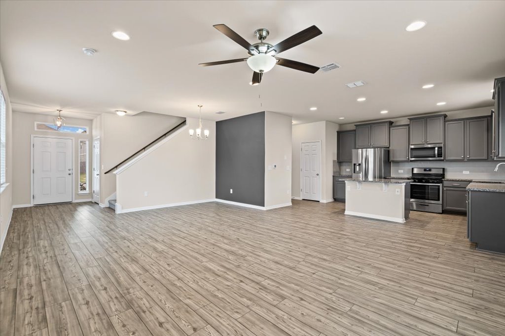 6313 Mary Lewis Drive Austin, TX 78747 - Photo 20 of 20 an open kitchen with wooden floor and stainless steel appliances