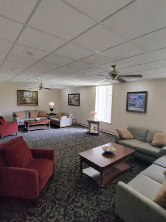 a spacious bedroom with a bed and a chandelier