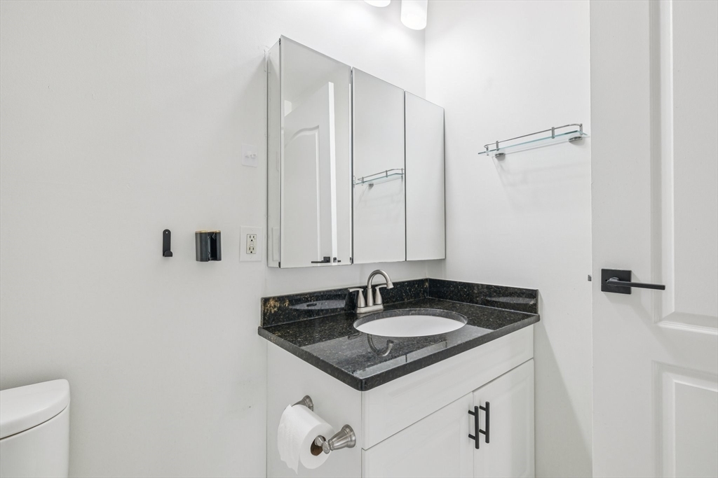 614 Pond Street, Unit 2104 Braintree, MA 02184 - Photo 16 of 29 a bathroom with a sink and a mirror