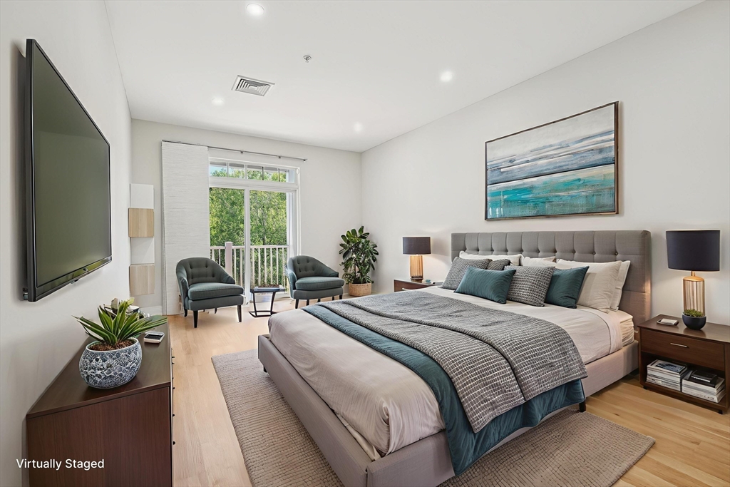 614 Pond Street, Unit 2104 Braintree, MA 02184 - Photo 10 of 29 a bedroom with bed and a flat screen tv