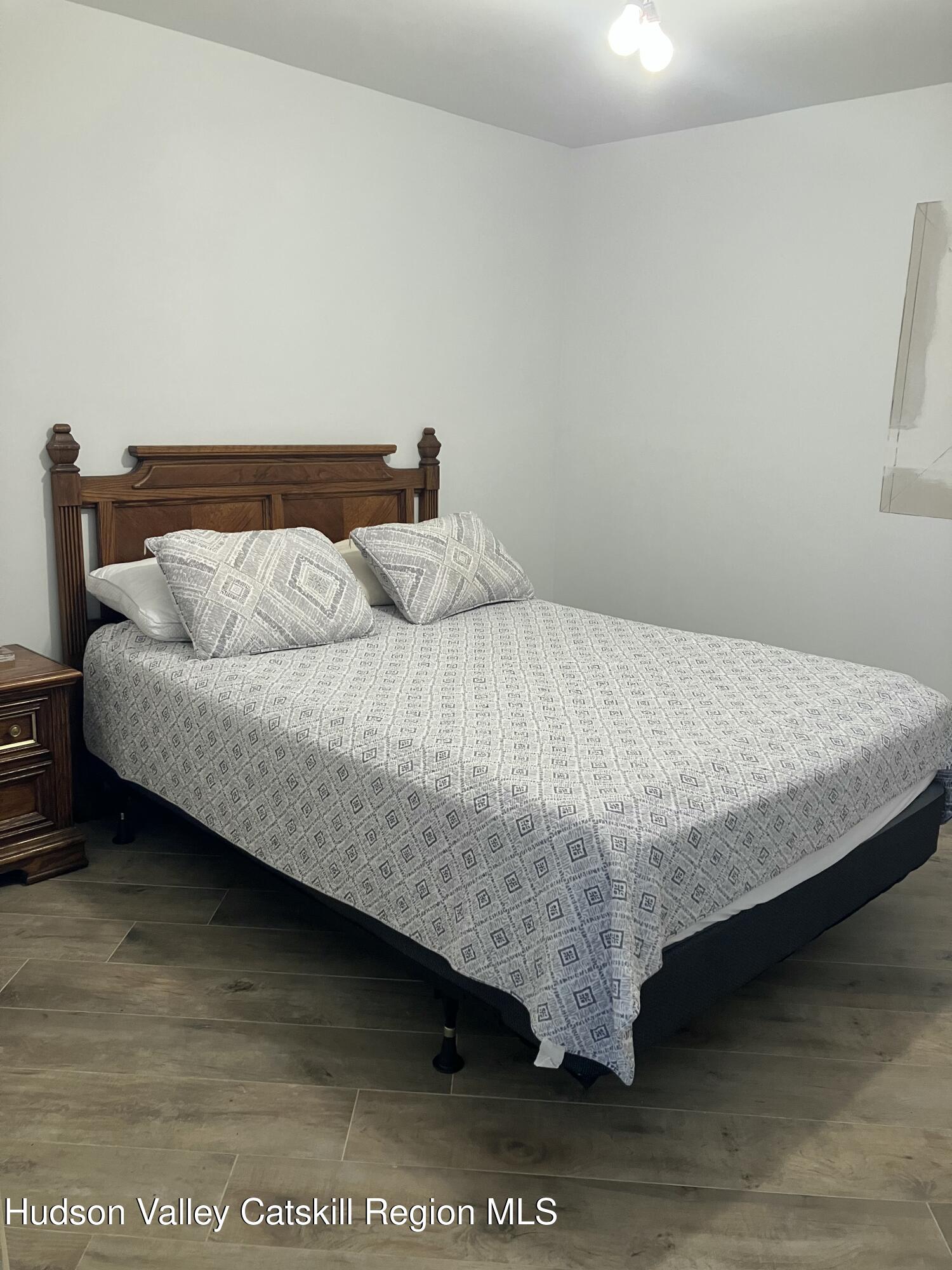 38 Bethel Ridge Road Catskill, NY 12414 - Photo 28 of 52 a bedroom with a bed and a night stand