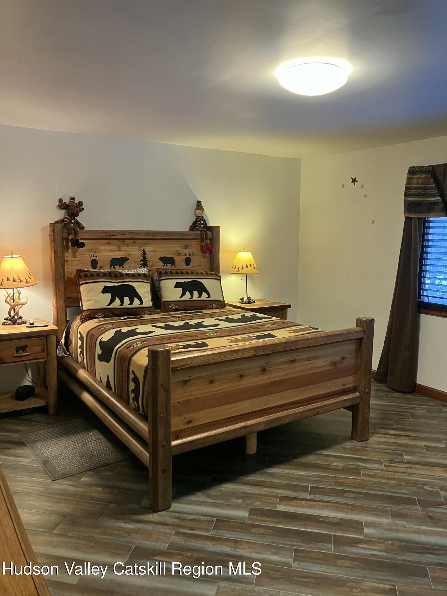 38 Bethel Ridge Road Catskill, NY 12414 - Photo 31 of 52 a bedroom with a bed and wooden floor
