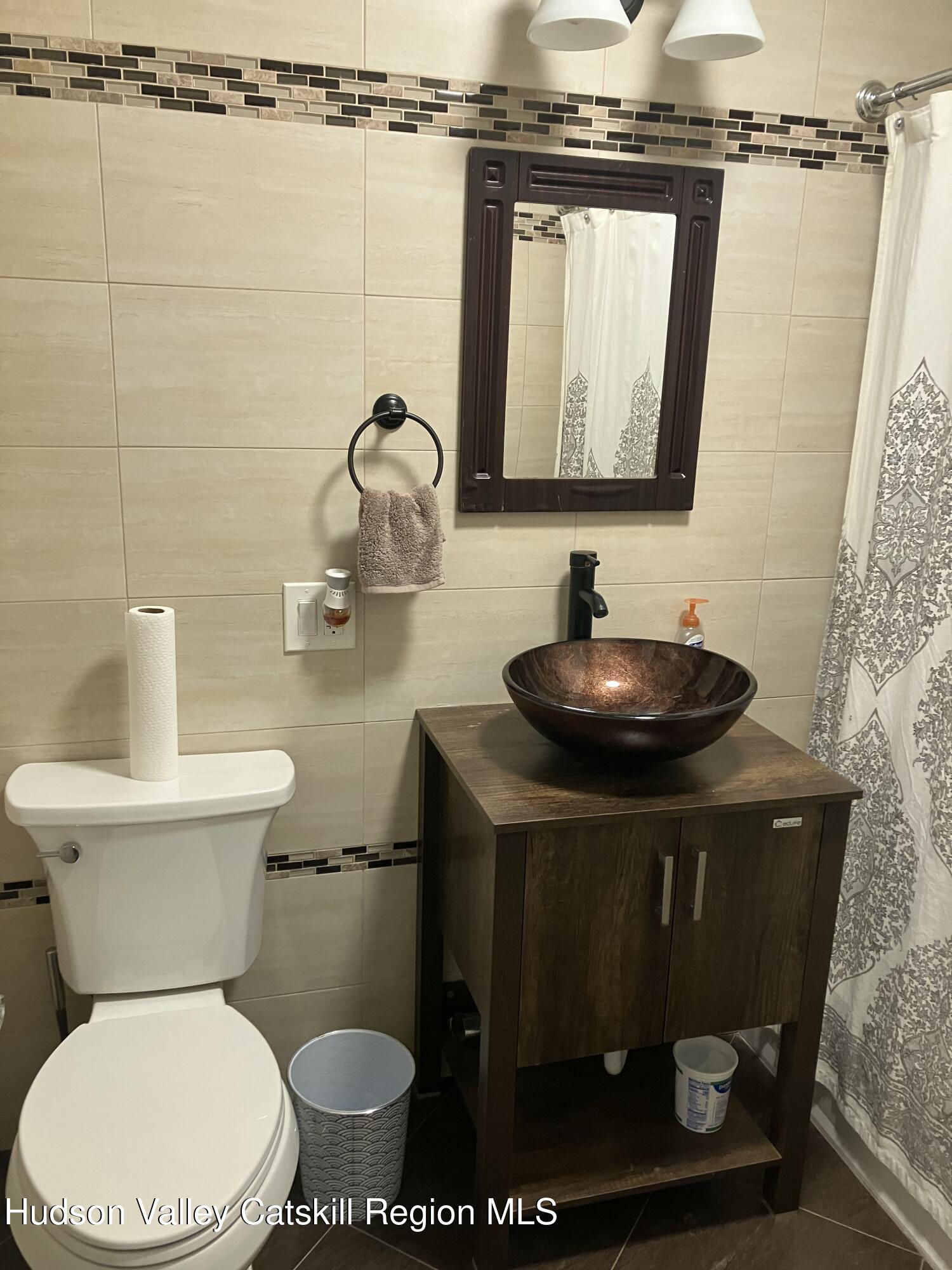 38 Bethel Ridge Road Catskill, NY 12414 - Photo 38 of 52 a bathroom with a toilet sink and mirror
