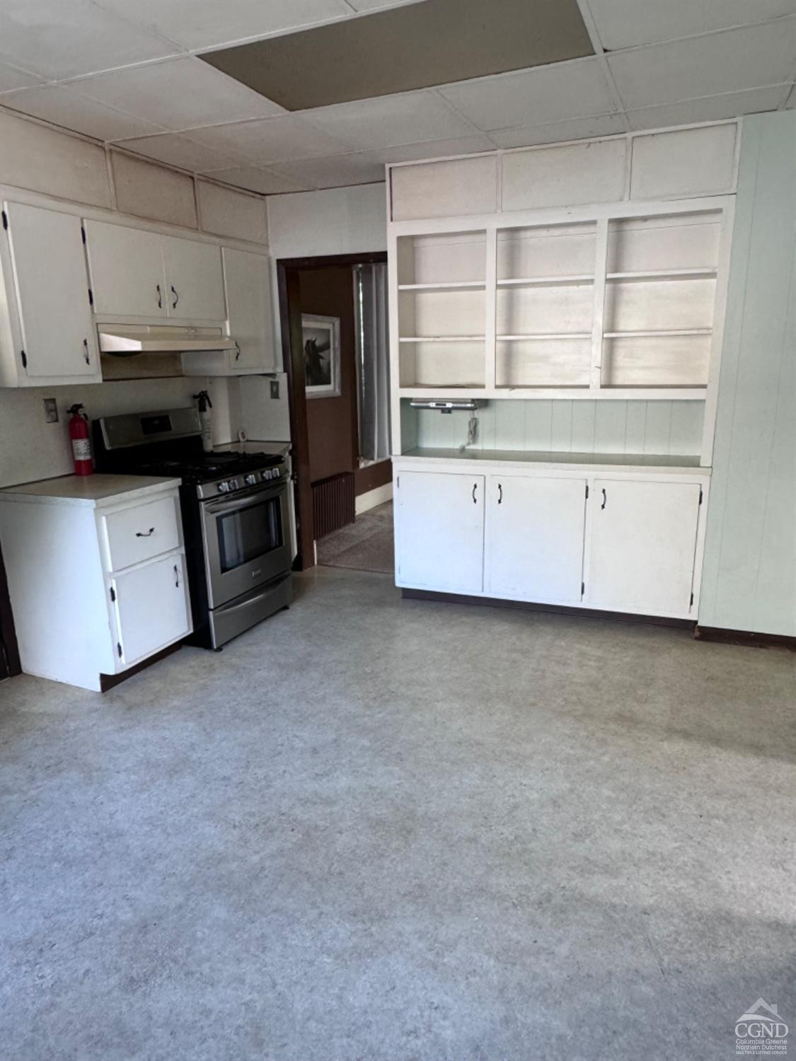 95 Maple Avenue Catskill, NY 12414 - Photo 13 of 25 a kitchen with stainless steel appliances a stove a refrigerator a sink a counter space and cabinets