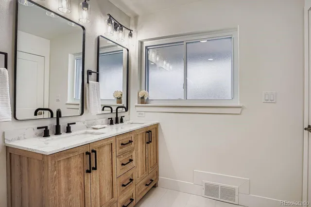 a bathroom with a double vanity sink and a mirror