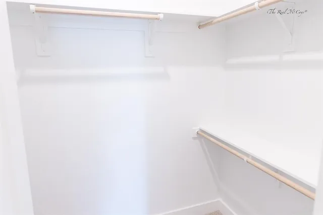 a bathroom with a granite countertop sink a mirror and a shower