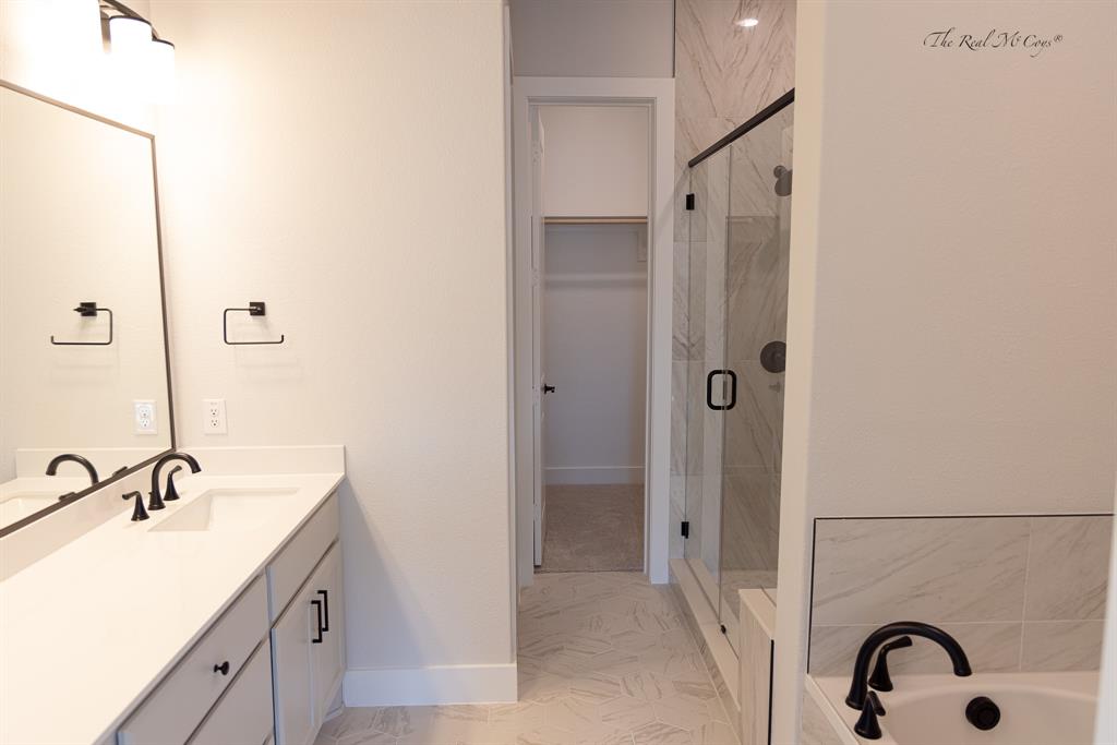 4328 Corn Husk Drive Frisco, TX 75033 - Photo 13 of 22 a bathroom with a granite countertop sink a mirror and a shower