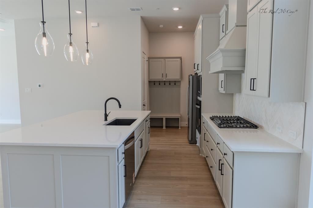 4328 Corn Husk Drive Frisco, TX 75033 - Photo 4 of 22 a kitchen with stainless steel appliances granite countertop a sink stove and refrigerator