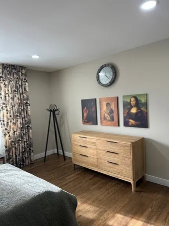 a view of a room with wooden floor furniture and windows