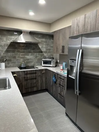 a kitchen with kitchen island a dining table and chairs