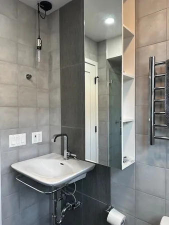 a white toilet sitting next to a window