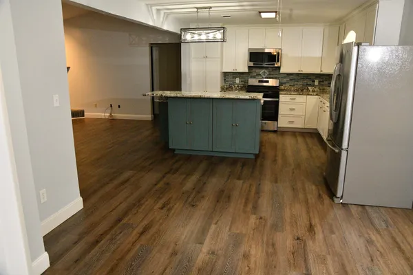a kitchen with a sink stove and refrigerator