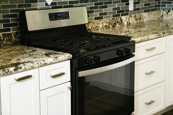 a kitchen with a sink stove and cabinets