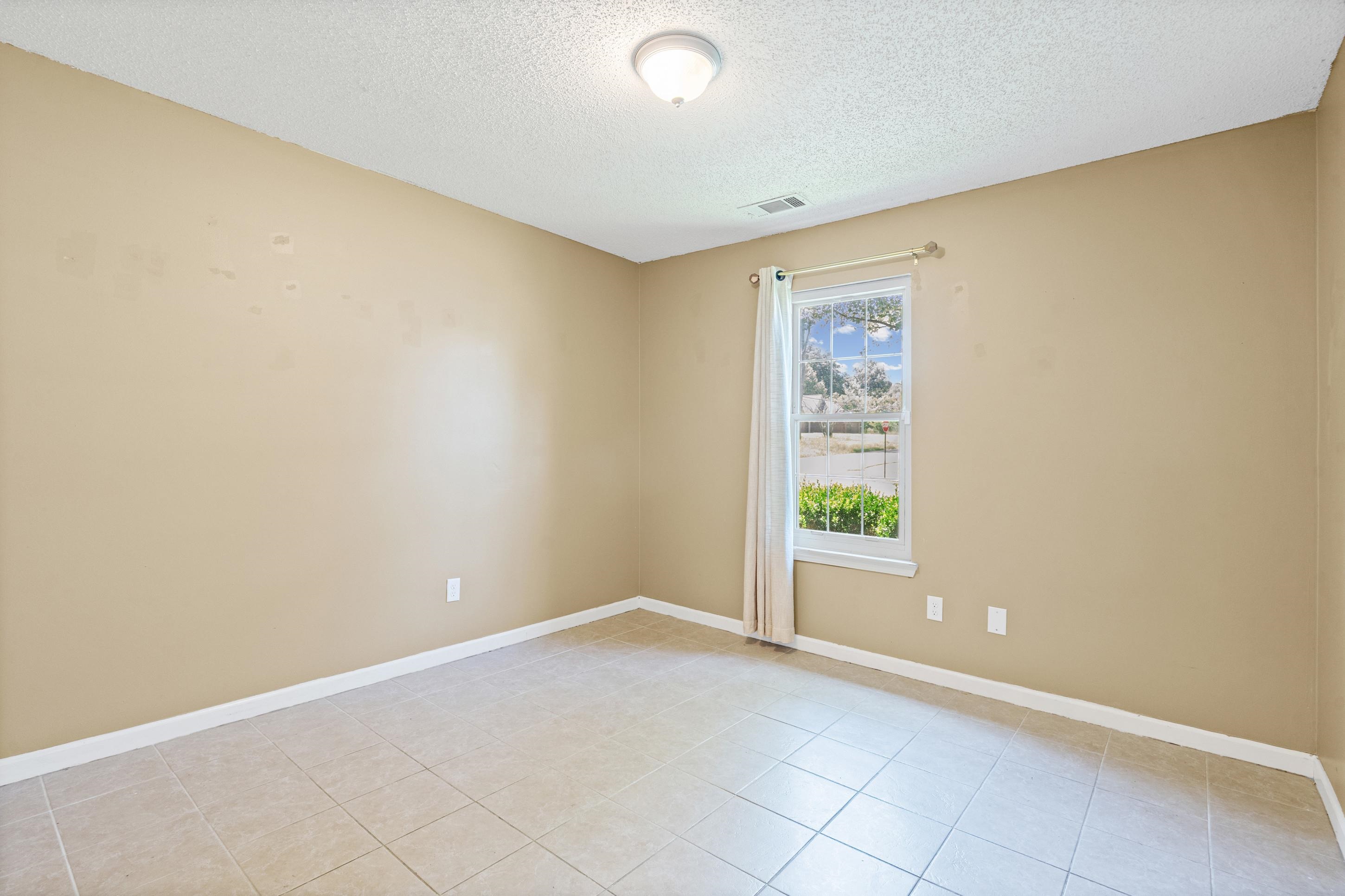 7130 Bryan Station Road Cordova, TN 38018 - Photo 16 of 26 Neutral-toned walls complement the square tile flooring throughout this space