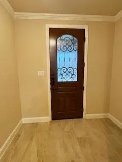 a view of a hallway with wooden door