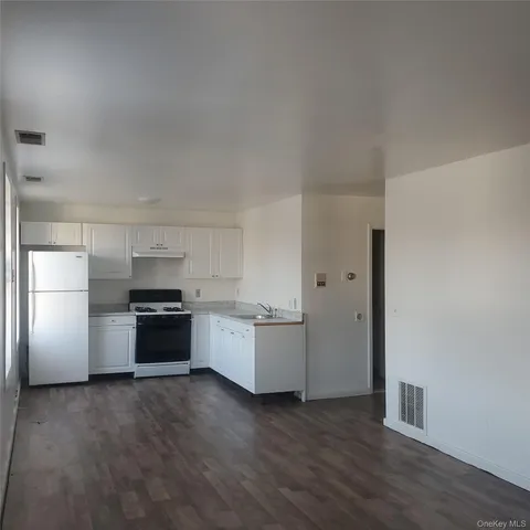 a kitchen with stainless steel appliances a refrigerator and a stove top oven