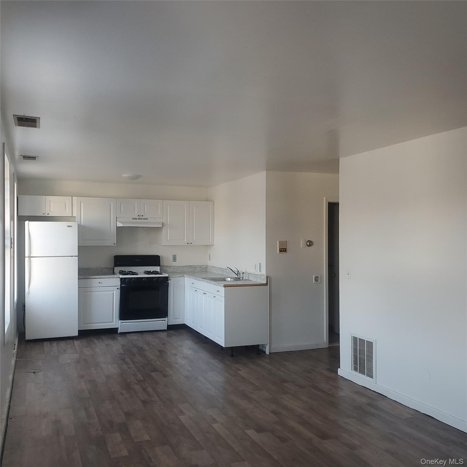 a kitchen with stainless steel appliances a refrigerator and a stove top oven