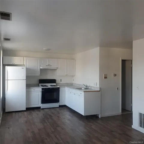 a kitchen with stainless steel appliances a refrigerator and a stove top oven