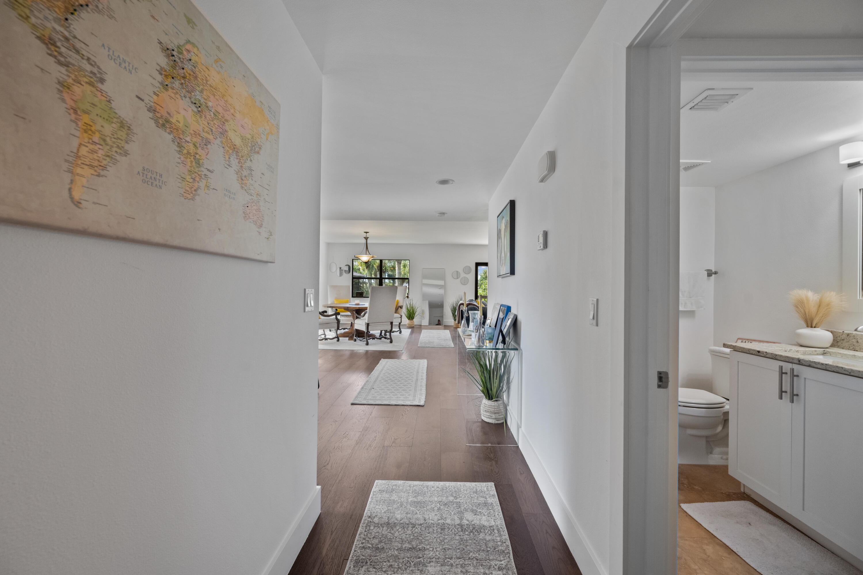 a view of a hallway and a livingroom with furniture