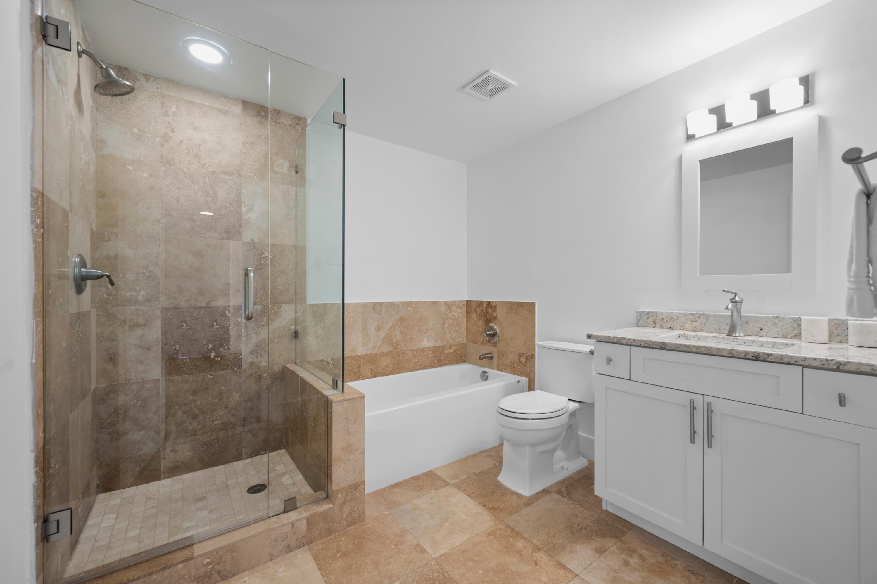 13388 Polo Road West, Unit 201 Wellington, FL 33414 - Photo 11 of 19 a bathroom with a shower sink vanity mirror and toilet