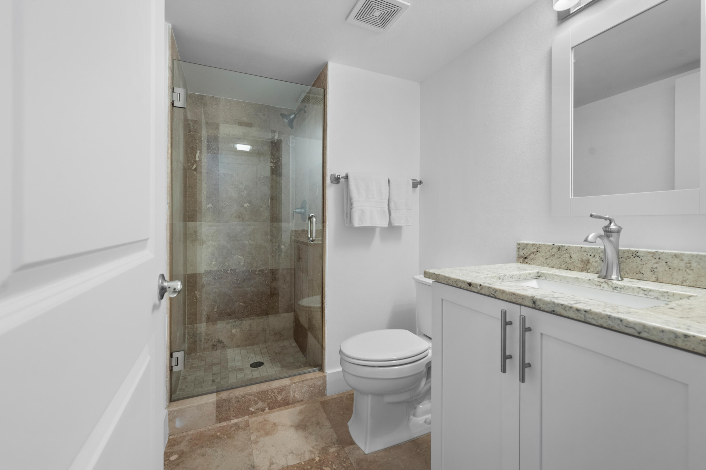 13388 Polo Road West, Unit 201 Wellington, FL 33414 - Photo 14 of 19 a bathroom with a granite countertop sink a toilet and shower