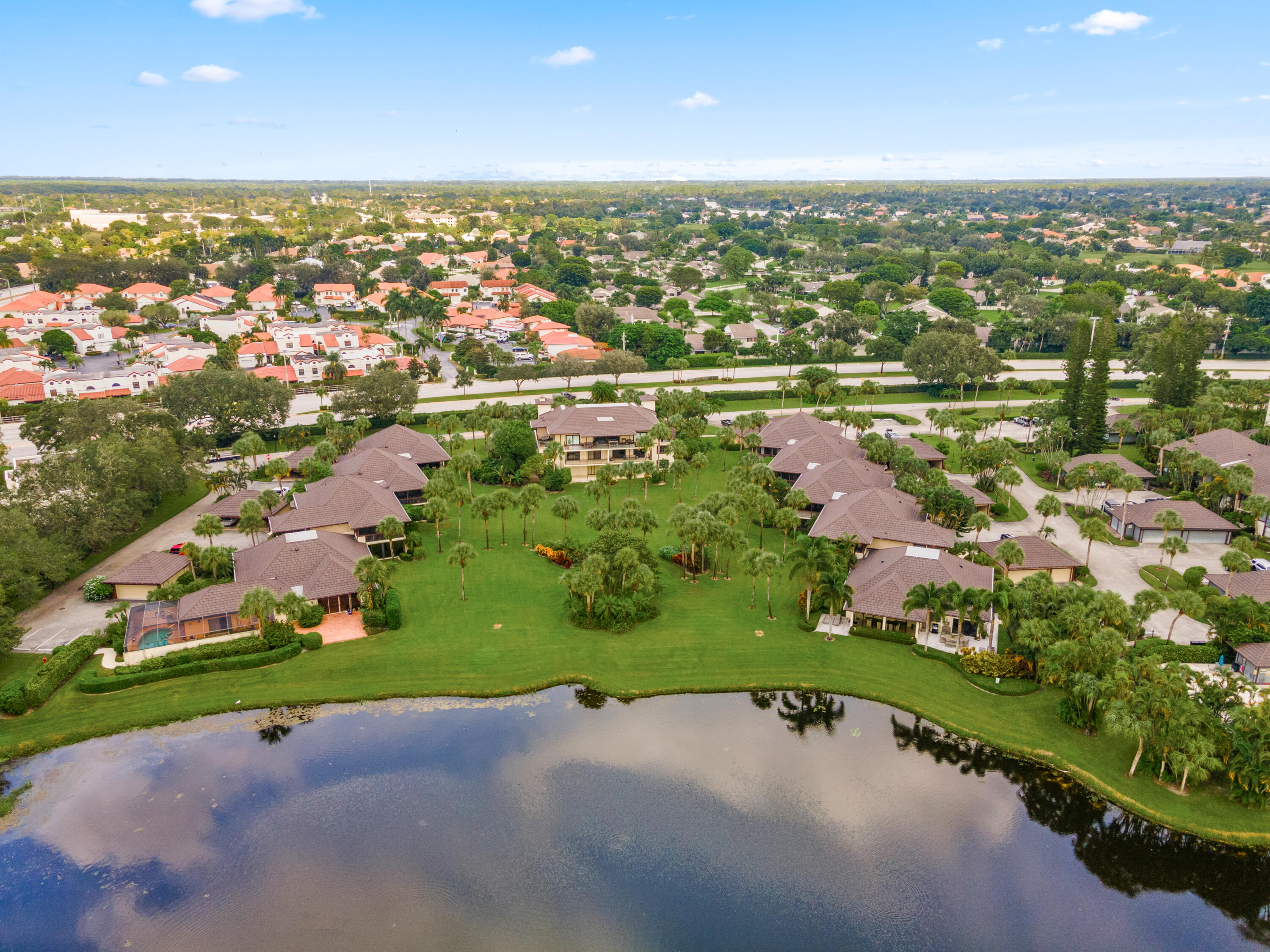 13388 Polo Road West, Unit 201 Wellington, FL 33414 - Photo 18 of 19 an aerial view of a houses with a yard and lake view