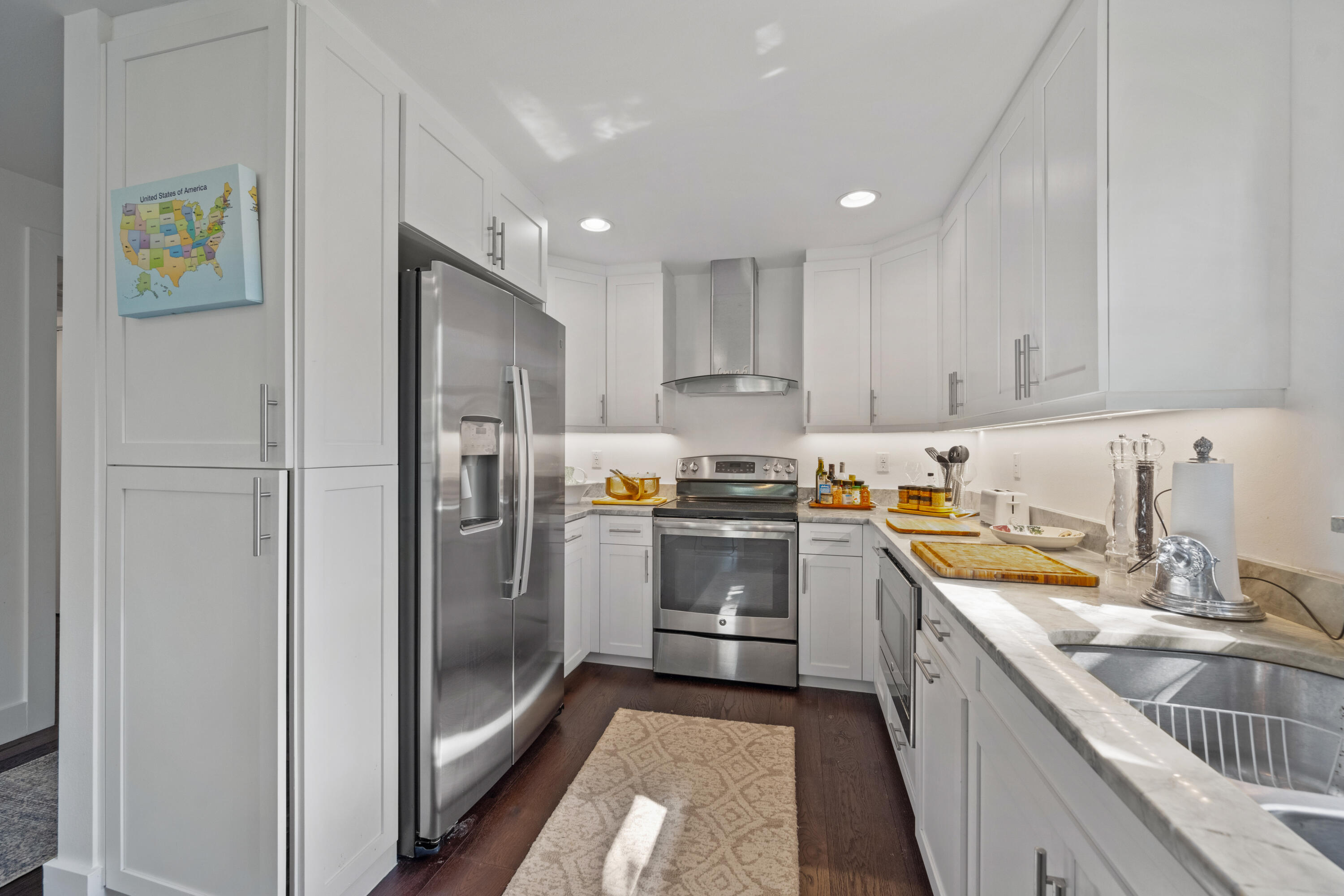 13388 Polo Road West, Unit 201 Wellington, FL 33414 - Photo 3 of 19 a kitchen with a refrigerator sink and cabinets