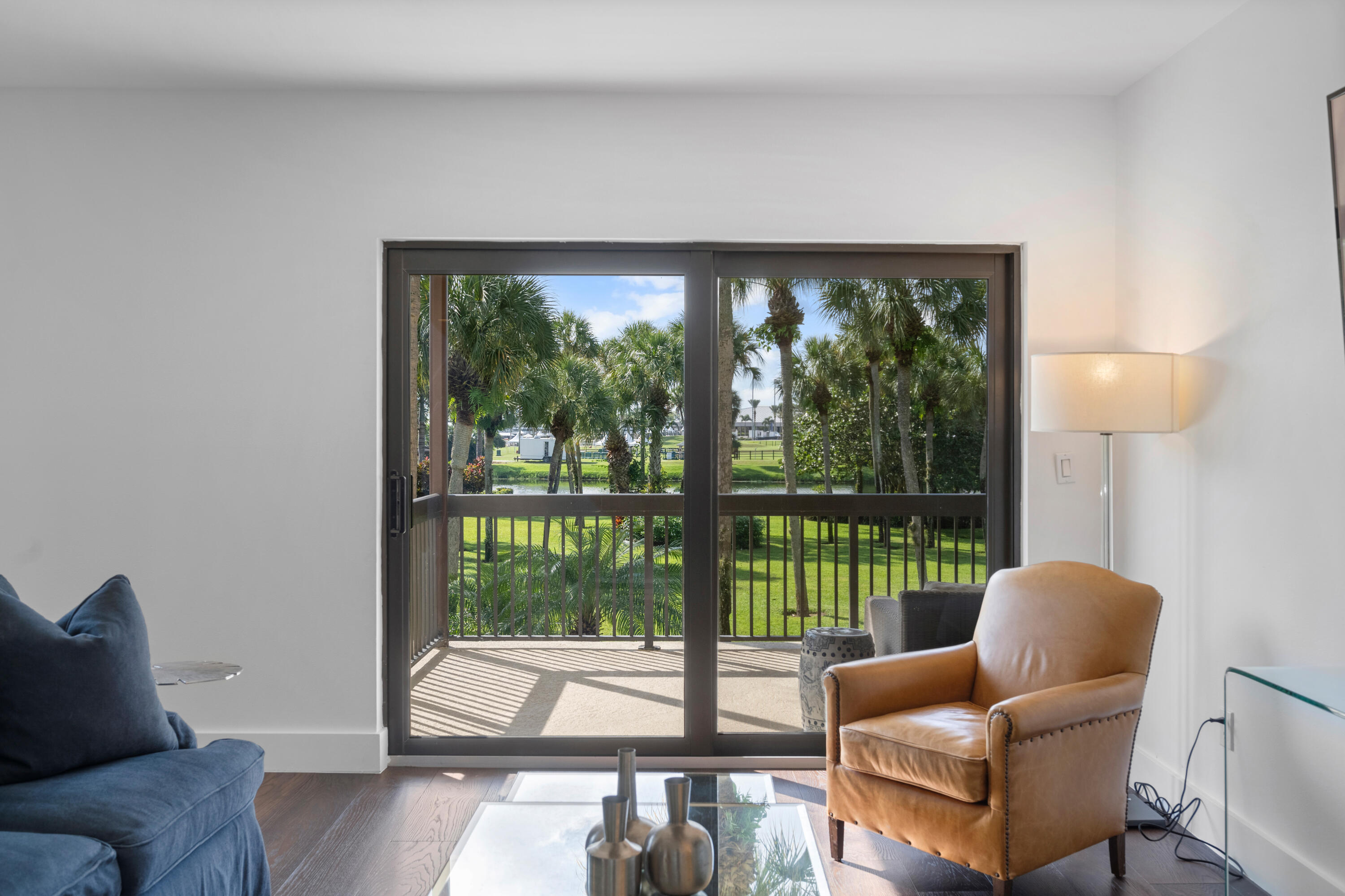 13388 Polo Road West, Unit 201 Wellington, FL 33414 - Photo 5 of 19 a living room with couch and a floor to ceiling window