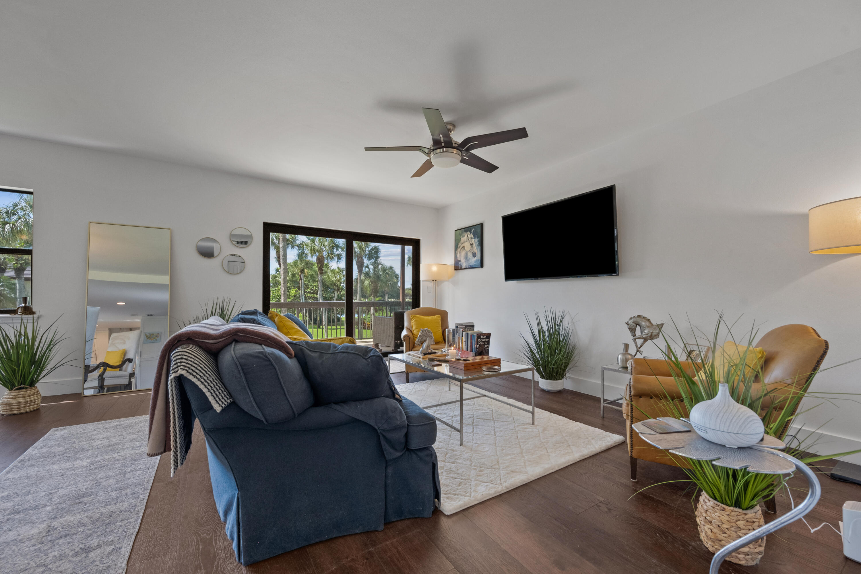 13388 Polo Road West, Unit 201 Wellington, FL 33414 - Photo 6 of 19 a living room with furniture and a flat screen tv