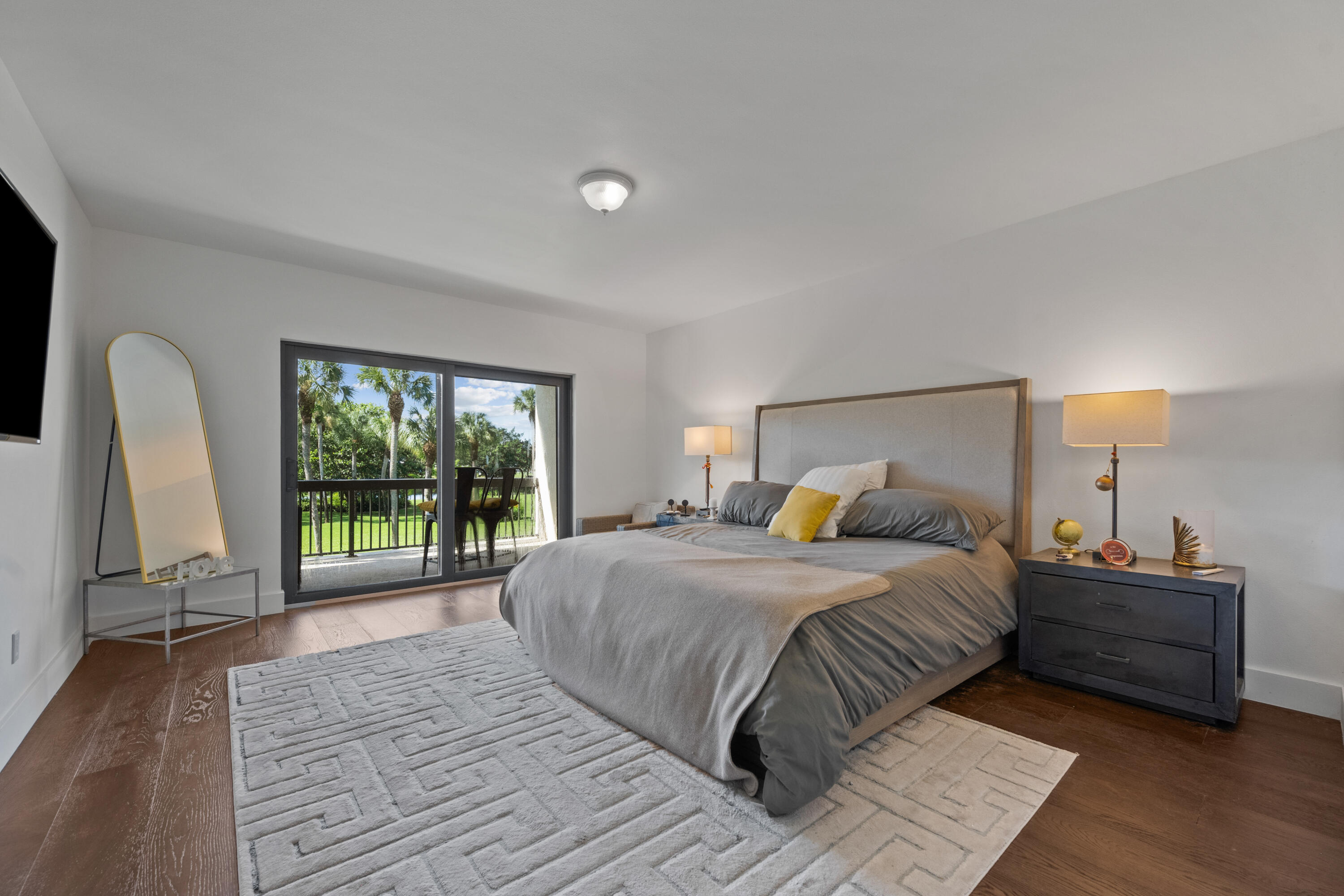 13388 Polo Road West, Unit 201 Wellington, FL 33414 - Photo 8 of 19 a bedroom with a bed window and a rug