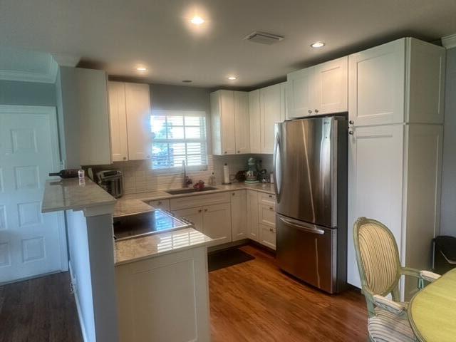 4585 Northwest 3rd Street, Unit D Delray Beach, FL 33445 - Photo 14 of 42 a kitchen with a refrigerator a sink and cabinets