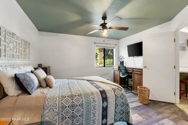 a bedroom with a bed and a flat screen tv