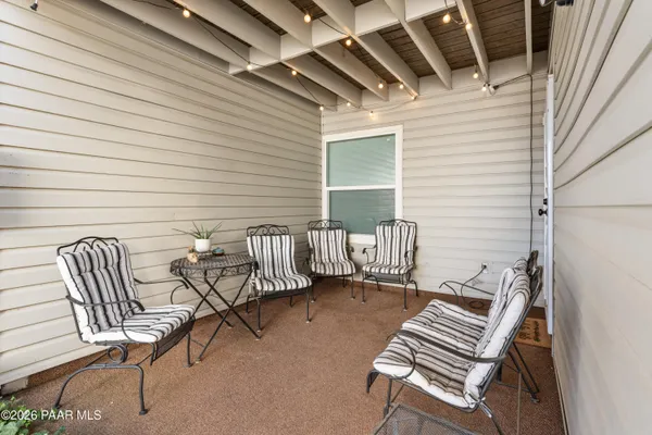 a balcony with two chairs and a table
