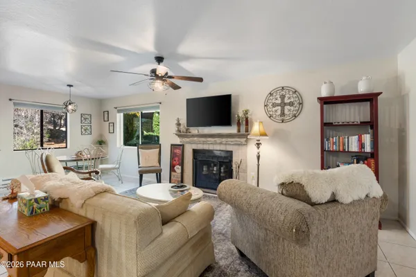 a living room with furniture a fireplace and a flat screen tv