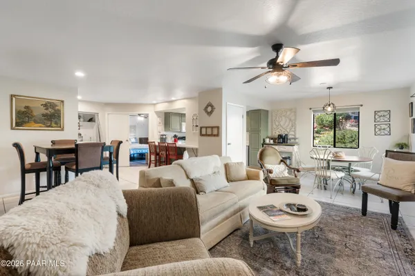 a living room with furniture a rug and a window