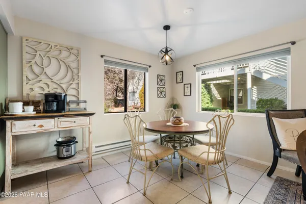 a dining room with furniture a chandelier and wooden floor