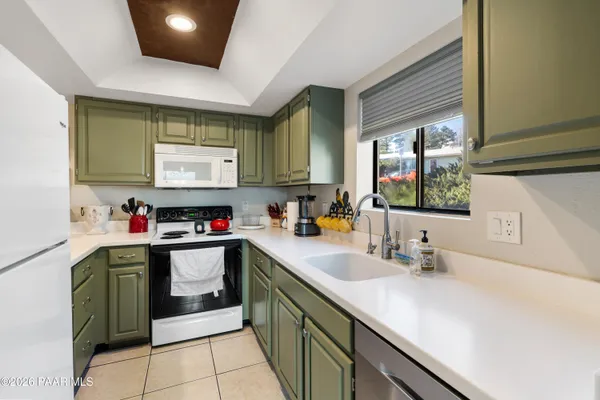 a kitchen with a sink cabinets and window