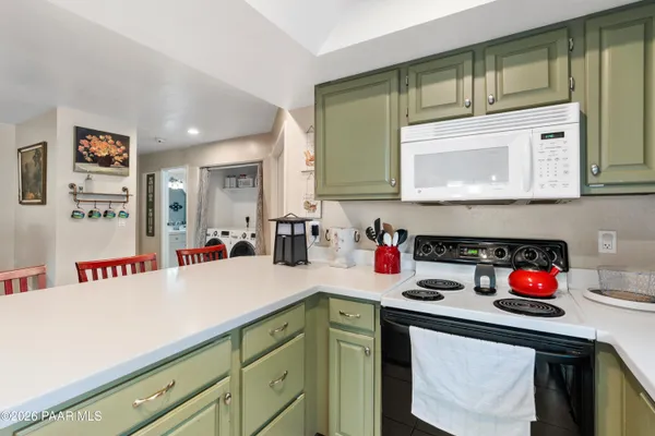 a kitchen with a cabinets a stove and a microwave