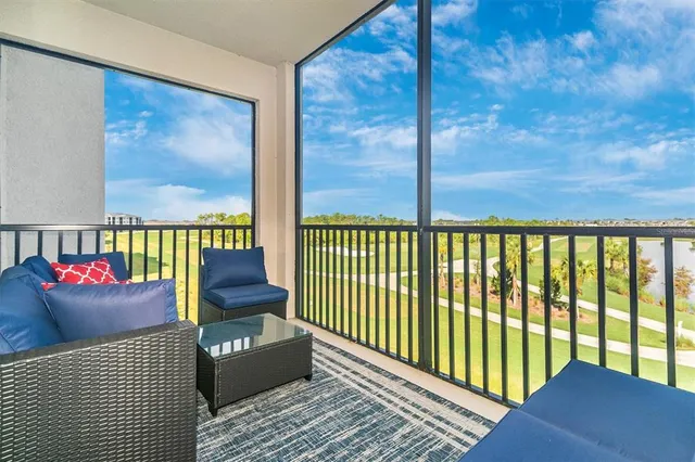 a dining room with furniture potted plants and wooden floor