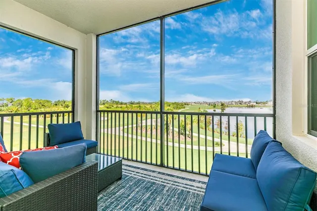 a kitchen with stainless steel appliances a stove a sink a stove a refrigerator white cabinets and wooden floor