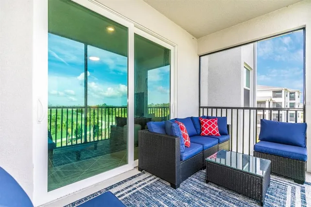 a kitchen with stainless steel appliances kitchen island granite countertop a dining table chairs stove refrigerator and cabinets