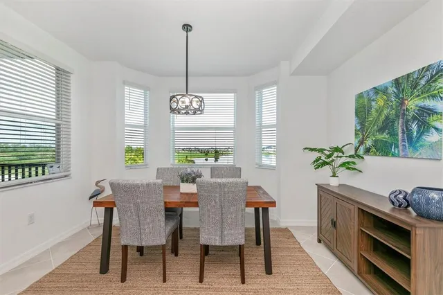 a kitchen with stainless steel appliances granite countertop a sink a stove a refrigerator and cabinets with wooden floor