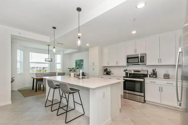 a bedroom with a bed and a flat tv screen on dresser