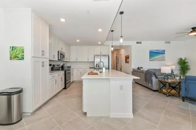 a bedroom with a bed and painting on the wall