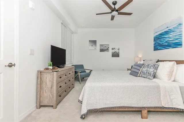 a bedroom with a bed and a painting on the wall