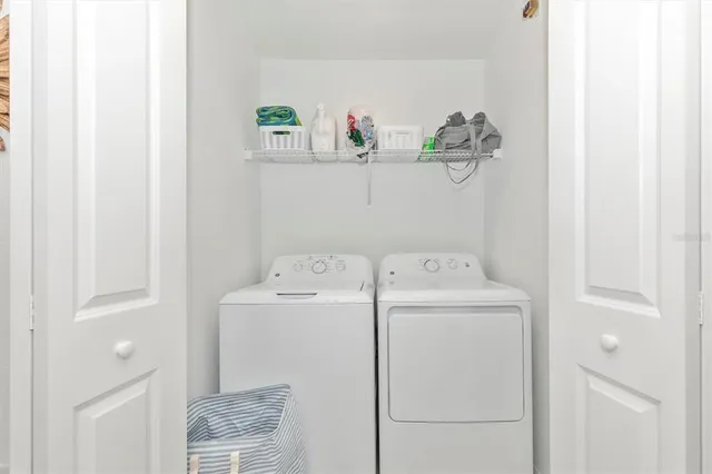 a dining room with lots of wooden furniture and a chandelier