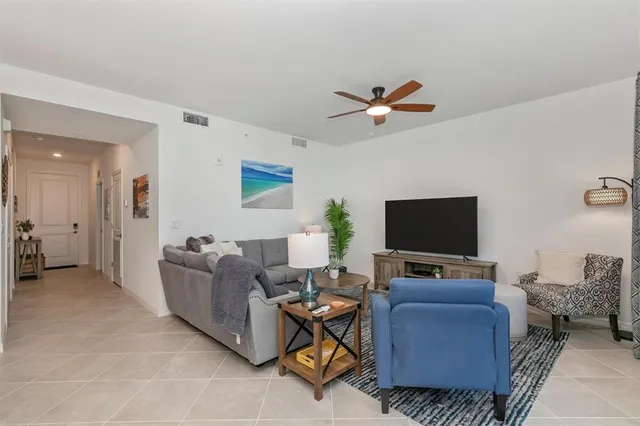 a living room with furniture and a floor to ceiling window