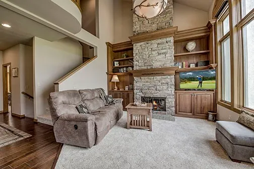 a kitchen with kitchen island granite countertop a sink cabinets stainless steel appliances and a counter top space